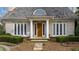 Brick home with a wood shingle roof, a covered porch, and a stone walkway at 6830 Vickery Creek Rd, Cumming, GA 30040