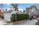 Three car garage and exterior of charming home with lush landscaping at 6830 Vickery Creek Rd, Cumming, GA 30040