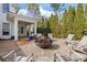 Inviting outdoor space with a central fire pit, comfortable seating, and a covered patio, perfect for relaxing and entertaining at 6830 Vickery Creek Rd, Cumming, GA 30040