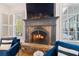 Close-up of the stone fireplace with a dark wood mantle, creating a warm and inviting atmosphere at 6830 Vickery Creek Rd, Cumming, GA 30040