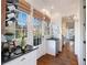 Bright hallway with white cabinetry, a wine rack, and access to outdoor views at 6830 Vickery Creek Rd, Cumming, GA 30040