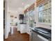 Well-lit hallway with white shiplap walls, a wine rack, and a view of the outdoor greenery at 6830 Vickery Creek Rd, Cumming, GA 30040