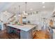 Bright kitchen with a large center island, modern appliances, and hardwood floors at 6830 Vickery Creek Rd, Cumming, GA 30040