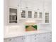 Bright kitchen featuring white cabinetry, glass-front cabinets, and marble countertops at 6830 Vickery Creek Rd, Cumming, GA 30040