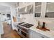 Modern kitchen features stainless steel appliances, white cabinets and marble countertops at 6830 Vickery Creek Rd, Cumming, GA 30040