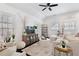 Bright living room featuring hardwood floors, comfortable seating, and abundant natural light through shuttered windows at 6830 Vickery Creek Rd, Cumming, GA 30040