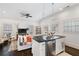 Bright and airy living room featuring a partial kitchen, ceiling fan, and open layout at 6830 Vickery Creek Rd, Cumming, GA 30040