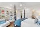 Main bedroom with built-in shelving and hardwood floors at 6830 Vickery Creek Rd, Cumming, GA 30040