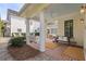 Picturesque patio featuring white columns, comfortable seating, and ceiling fan is perfect for outdoor entertaining at 6830 Vickery Creek Rd, Cumming, GA 30040