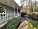 View of the front porch with a white railing and landscaping at 1200 Lakewood Ne Dr, Conyers, GA 30013