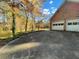 Exterior view of the garage with parking spaces in front and lake in background at 1200 Lakewood Ne Dr, Conyers, GA 30013