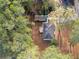 Aerial view of a property showcasing its location amidst lush greenery and a storage shed at 4760 Hillside Dr, Acworth, GA 30101