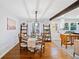 Charming dining room with hardwood floors, decorative shelves, and a pendant light fixture at 4760 Hillside Dr, Acworth, GA 30101