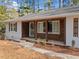 Inviting front porch with a decorative green door and beautiful wood and white painted accents at 4760 Hillside Dr, Acworth, GA 30101