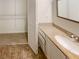 Bathroom vanity with a granite countertop, large mirror and view of the walk-in closet at 2007 Variations Ne Dr, Atlanta, GA 30329
