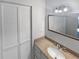 Well-lit bathroom featuring a large mirror, granite countertop, and white cabinets at 2007 Variations Ne Dr, Atlanta, GA 30329