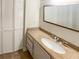 Bathroom featuring a vanity with a granite countertop and a large mirror, with a view to folding closet doors at 2007 Variations Ne Dr, Atlanta, GA 30329