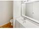 A clean half bathroom featuring a modern vanity with white countertops and a mirror at 2007 Variations Ne Dr, Atlanta, GA 30329