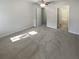 A gray bedroom has an open door to the bathroom, carpet, and a ceiling fan at 2007 Variations Ne Dr, Atlanta, GA 30329