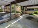 Open carport with a concrete pad, supported by black metal poles, near landscaping at 2007 Variations Ne Dr, Atlanta, GA 30329