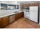 A bright kitchen features white appliances and cabinets and terra cotta floors at 2007 Variations Ne Dr, Atlanta, GA 30329