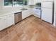 Updated kitchen with white cabinets, stainless steel dishwasher, and light countertops at 2007 Variations Ne Dr, Atlanta, GA 30329