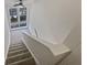 Carpeted staircase with a large window allowing natural light to flood the landing at 2007 Variations Ne Dr, Atlanta, GA 30329
