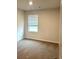 Neutral bedroom featuring a window letting in lots of natural light at 107 Meadowview Dr # 23, Temple, GA 30179