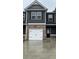 Charming townhome with a white garage door and a mix of brick and gray siding at 107 Meadowview Dr # 23, Temple, GA 30179