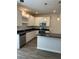 The kitchen features stainless steel appliances and an island with dark countertops at 107 Meadowview Dr # 23, Temple, GA 30179