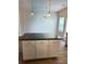 This kitchen features an island with white cabinets and a dark countertop for a modern look at 107 Meadowview Dr # 23, Temple, GA 30179
