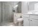 Modern bathroom features a glass-enclosed shower with gray tile and white vanity at 5453 Battery Ln #20 Ln, Atlanta, GA 30342