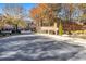 Community brick entrance to Carriage Gate community framed by Autumn trees at 5453 Battery Ln #20 Ln, Atlanta, GA 30342