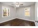 Bright bedroom featuring two windows and hardwood flooring at 1723 Capistrana Pl, Decatur, GA 30032