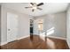 Sun-filled bedroom featuring a ceiling fan, hardwood floors, and two closets at 1723 Capistrana Pl, Decatur, GA 30032