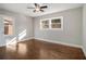 Spacious bedroom showcasing hardwood floors, ceiling fan, and natural lighting at 1723 Capistrana Pl, Decatur, GA 30032