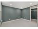 A spacious bedroom with grey walls, white trim, and an open closet provides a clean and functional space at 1723 Capistrana Pl, Decatur, GA 30032