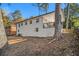 An exterior shot of the white brick home with a quaint porch and a wooded lot at 1723 Capistrana Pl, Decatur, GA 30032