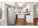 Bright kitchen with stainless steel refrigerator, white cabinets, and hardwood flooring at 1723 Capistrana Pl, Decatur, GA 30032