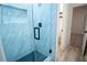 Sleek bathroom with a glass shower door and hexagon tile flooring at 1330 Lockwood Sw Dr, Atlanta, GA 30311