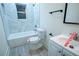 Updated bathroom with white vanity, new toilet, and marble shower at 1330 Lockwood Sw Dr, Atlanta, GA 30311