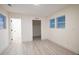 Simple bedroom with light walls, wood-look floors, and multiple windows at 1330 Lockwood Sw Dr, Atlanta, GA 30311