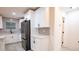 Modern white kitchen with stainless steel appliances and gray tile backsplash at 1330 Lockwood Sw Dr, Atlanta, GA 30311