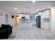 Modern kitchen with white cabinets, island, stainless steel appliances, and gray backsplash at 1330 Lockwood Sw Dr, Atlanta, GA 30311