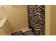 Bathroom featuring a zebra-print shower curtain and matching floor mats at 2562 Pendergrass Ct, Ellenwood, GA 30294