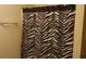 Bathroom featuring a striking zebra-print shower curtain and a towel rack at 2562 Pendergrass Ct, Ellenwood, GA 30294