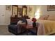 Comfortable primary bedroom featuring chair, dresser, and queen size bed at 2562 Pendergrass Ct, Ellenwood, GA 30294
