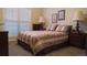 Cozy bedroom featuring a large bed with decorative bedding, bedside tables, and ample natural light from the window at 2562 Pendergrass Ct, Ellenwood, GA 30294