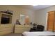 Bright bedroom featuring a TV and shelving unit, dresser with mirror and an armchair, lit by a window with wood-look blinds at 2562 Pendergrass Ct, Ellenwood, GA 30294