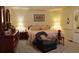 Spacious primary bedroom featuring warm lighting, a comfortable sitting area, and tasteful decor at 2562 Pendergrass Ct, Ellenwood, GA 30294